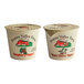 Two Pequea Valley Farm yogurt cups with red and black labels containing raspberry and black cherry yogurt.