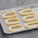 A baking sheet with White Toque churro loops on it.