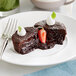 A vegan flourless chocolate cake with a strawberry on top.