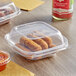 Two Inline Plastics Safe-T-Chef plastic containers with food inside.