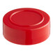 A red plastic cap with a circle on top.