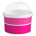A pink and white Choice paper frozen yogurt container with a clear dome lid.