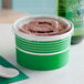 A green Choice paper frozen yogurt container with a flat lid.