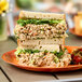 A plate with two sandwiches of Sunneen Ready-to-Serve Vegan Stedda Tuna Salad.