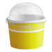 A yellow and white Choice paper frozen yogurt cup with a clear dome lid.