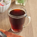 A glass mug of Caribou Coffee Decaf Caribou Blend coffee.