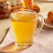 A glass of Bigelow Lemon and Echinacea Herbal Tea with a lemon slice.