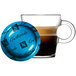 A glass cup of brown Nespresso Professional Guatemala coffee with a blue lid.