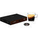 A black box of Nespresso Professional Intenso Single Serve Coffee Capsules on a table with a glass of coffee.