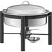 An Acopa wrought iron chafing dish with a lid on a table outdoors.