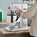 A person using a Estella countertop mixer.
