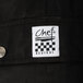 A close up of Chef Revival black cargo pants with a black and white label.
