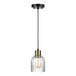 A Globe Glam pendant light with a ribbed clear glass shade and a black and gold pole.