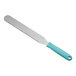 A Wilton baking / icing spatula with a blue plastic handle and a straight serrated blade.