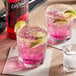 Two glasses of DaVinci Gourmet Prickly Pear drinks with limes and salt on the rim.