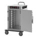 A silver metal Metro heated holding cabinet with a door open on a silver cart.