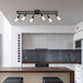 A kitchen island with a Globe matte black industrial light fixture above it.