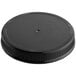 A black ribbed plastic cap with a foam liner on a table.