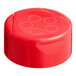 A red plastic Flip and Sift spice lid on a counter.