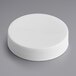 A 45/400 white plastic cap with a foam liner on a gray surface.