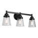 A Canarm Declan matte black vanity light with three clear seeded glass shades.
