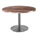 A Holland Bar Stool EnduroTop round wooden table with a stainless steel base.