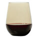 A Tossware Smoke Tritan plastic stemless wine glass filled with red wine.