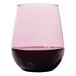 A Tossware Reserve Go-To Blush Tritan plastic stemless wine glass with a red rim.