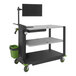 A black Newcastle Systems PC Series mobile workstation with a screen and a green bucket.