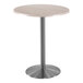 A Holland Bar Stool EnduroTop round white ash table with metal base.