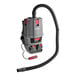 A grey and red Sanitaire Transport cordless backpack vacuum cleaner with a hose attached.
