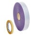 A roll of purple plastic tape with a white and blue label.