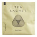 A close up of a green Dona Supertwist tea sachet with a black triangle in the middle.