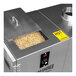 A Pro Smoker Pellet Smoke Generator machine with a metal container full of wood pellets and a lid open.