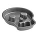 A black fluted cake pan with three skull-shaped molds.