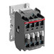 A grey electrical contactor with white and black buttons and two contacts.