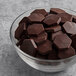 A bowl of TCHO dark chocolate hexagons.