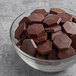A bowl of TCHO Real Fudgy 70% dark chocolate hexagons.