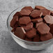 A bowl of TCHO Real Fruity dark chocolate hexagons.