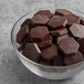 A bowl of TCHO Hella Dark chocolate hexagons.