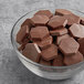 A bowl of TCHO Sweet & Sassy dark chocolate hexagons.