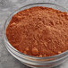 A bowl of TCHO unsweetened cocoa powder.