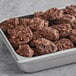 A tray of Otis Spunkmeyer chocolate turtle cookies with nuts.