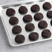A tray of Otis Spunkmeyer whole grain chocolate brownie cookies on a white surface.