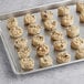A gray tray filled with Otis Spunkmeyer Oatmeal Raisin cookies.