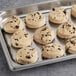 A tray of Otis Spunkmeyer chocolate chip cookies on a gray surface.