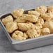 A tray of Otis Spunkmeyer Supreme Indulgence preformed nutty white chunk cookies.