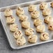 A tray of Otis Spunkmeyer strawberry shortcake cookies on a gray surface.