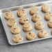 A silver tray with a cookie made from Otis Spunkmeyer chocolate chip cookie dough.