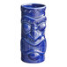 An Acopa blue ceramic tiki mug with a face carved on it.